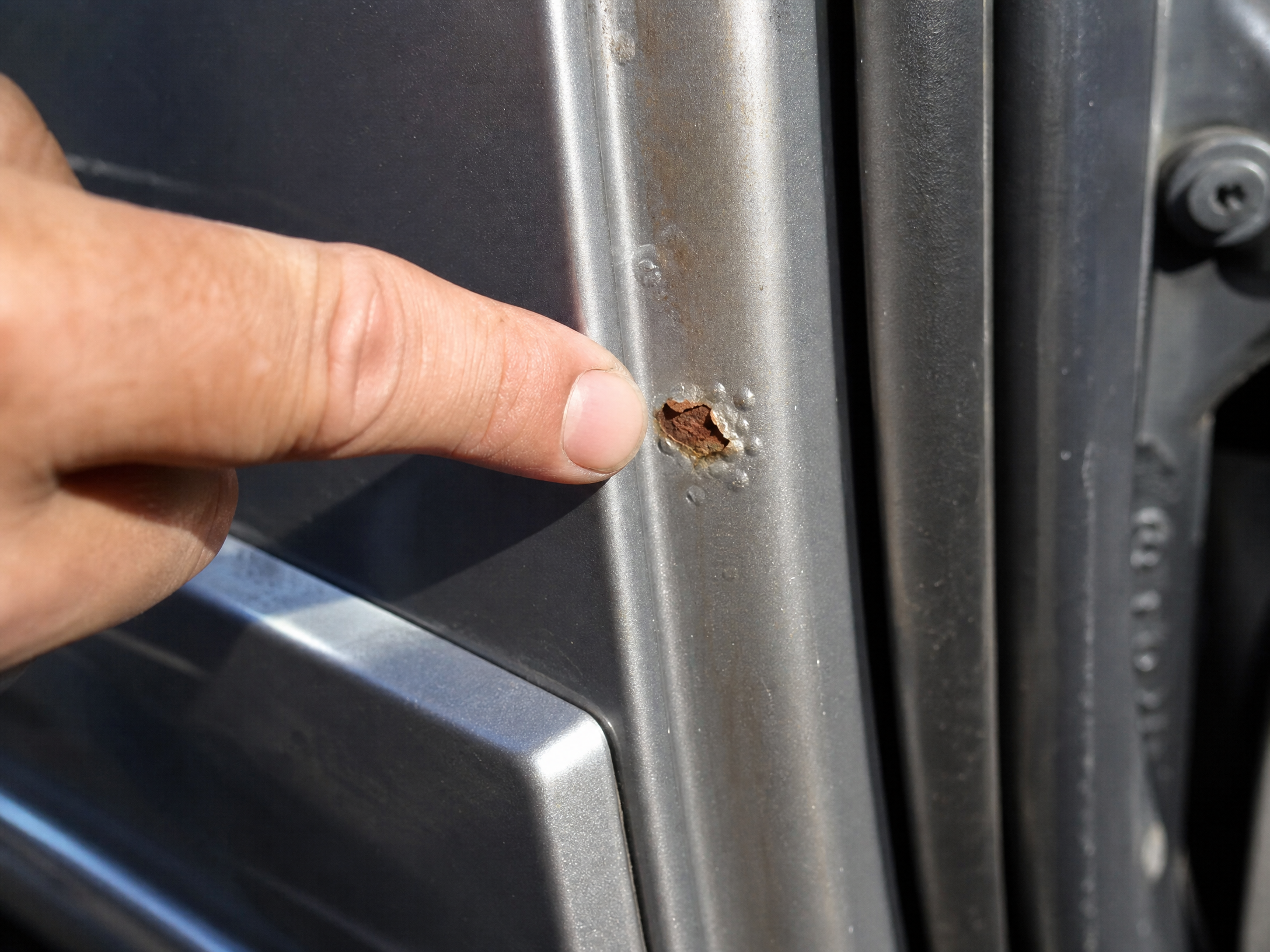 Small rust spot on a car door edge