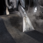 Steam cleaning car carpet and upholstery during interior detailing