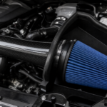 Cold air intake and blue performance filter in a car engine bay