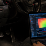 Laptop ECU tuning software connected to a car through the OBD port