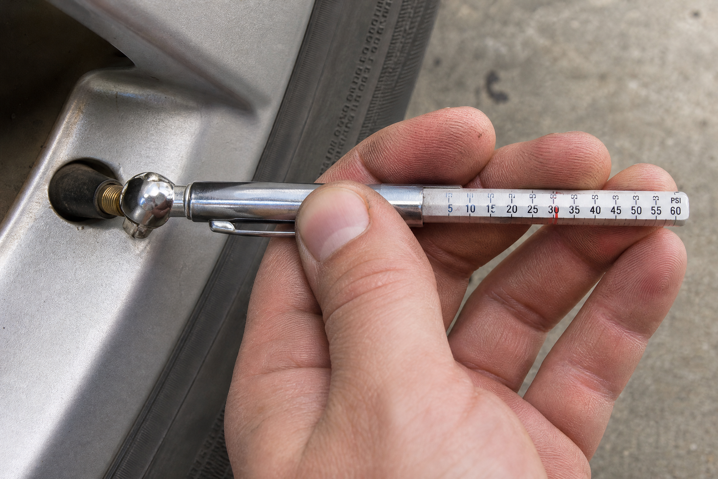 Tire pressure placard sticker on the driver door jamb listing recommended psi